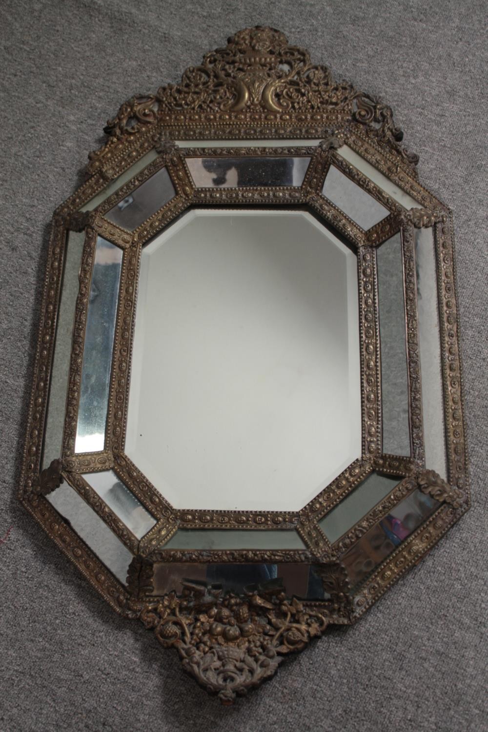 Wall mirror, C.1900 Dutch style in repousse metal cushion frame. H.109 W.62cm. - Image 4 of 5