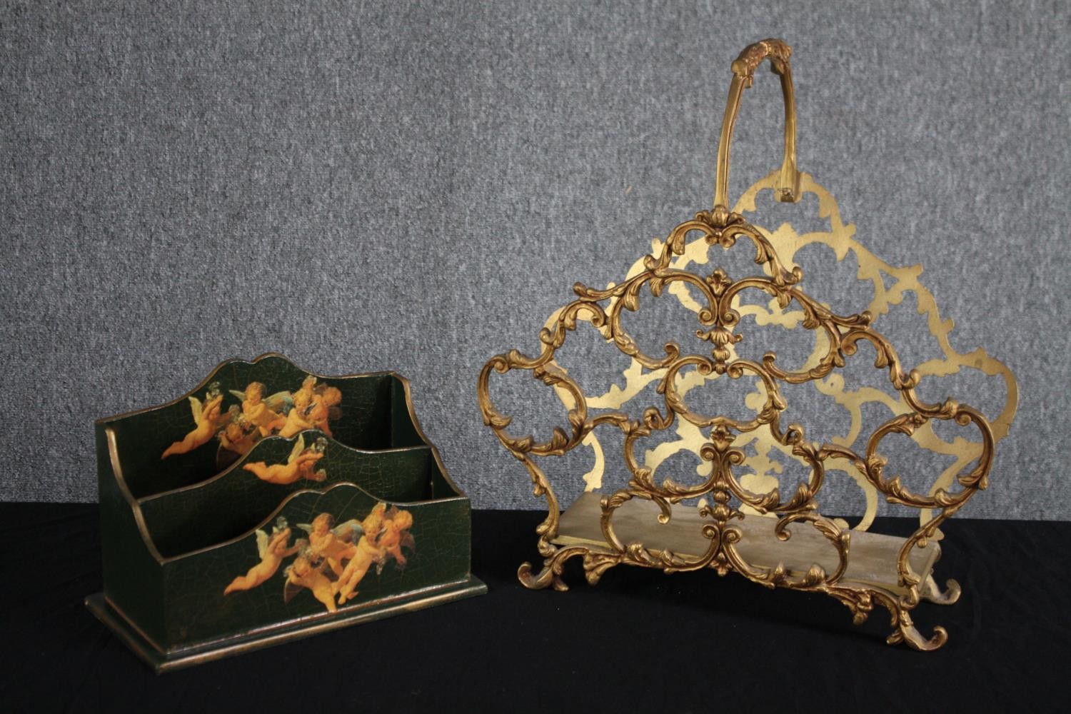 A lacquered letter rack decorated with cherubs and a gilt metal pierced foliate design magazine