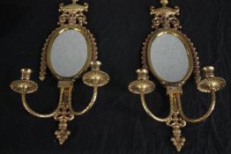 A pair of brass mirrored sconces with two branch candle holders. H.59cm. (each)