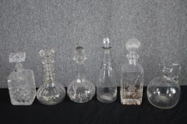A collection of five 19th and early 20th century decanters and a wine jug. All decanters are