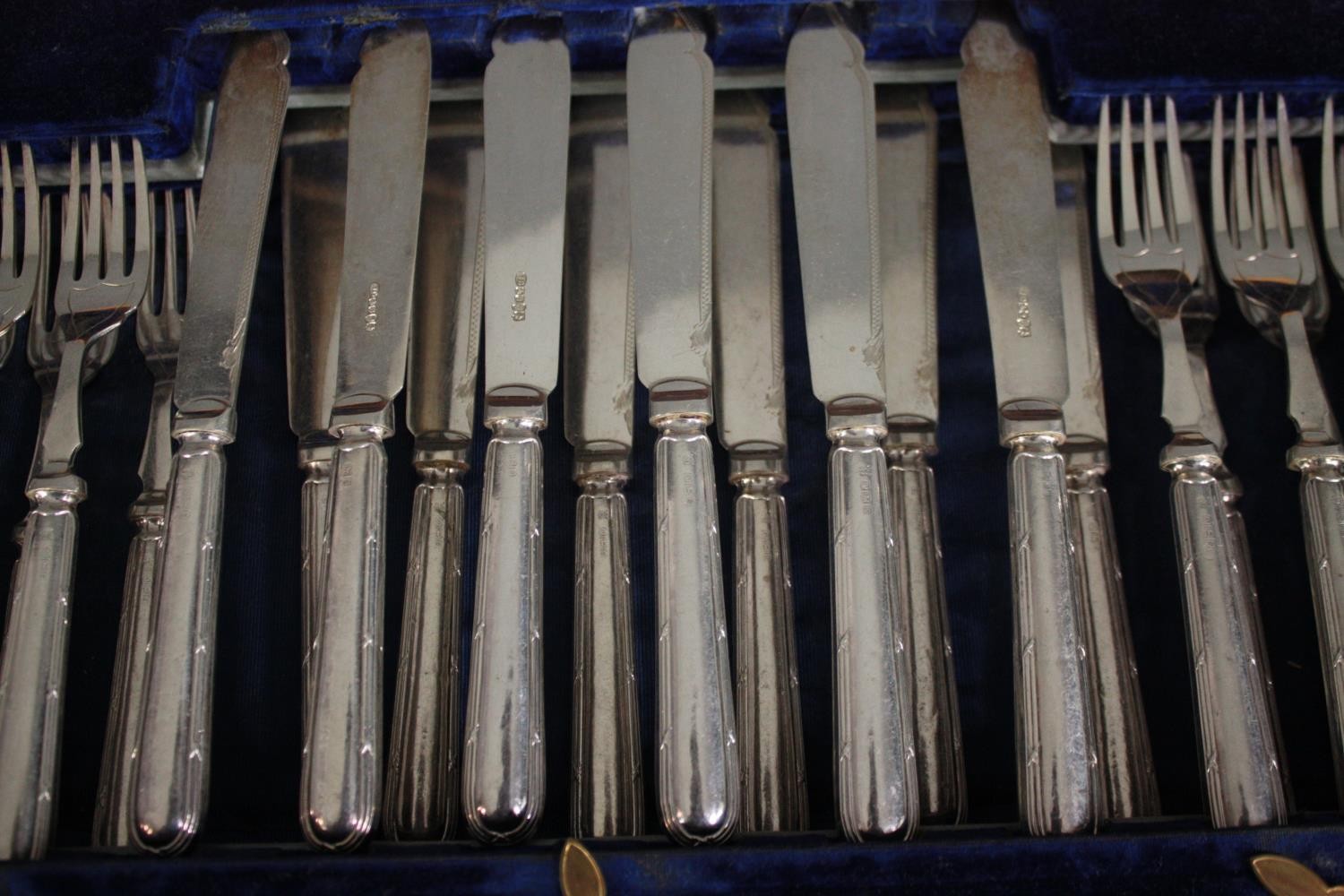 A complete Victorian mahogany canteen of silver plate cutlery for twelve people. The handles with - Image 3 of 6