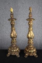 A pair of early 20th century gilt brass repousse foliate design table lamps. H.59cm. (each)