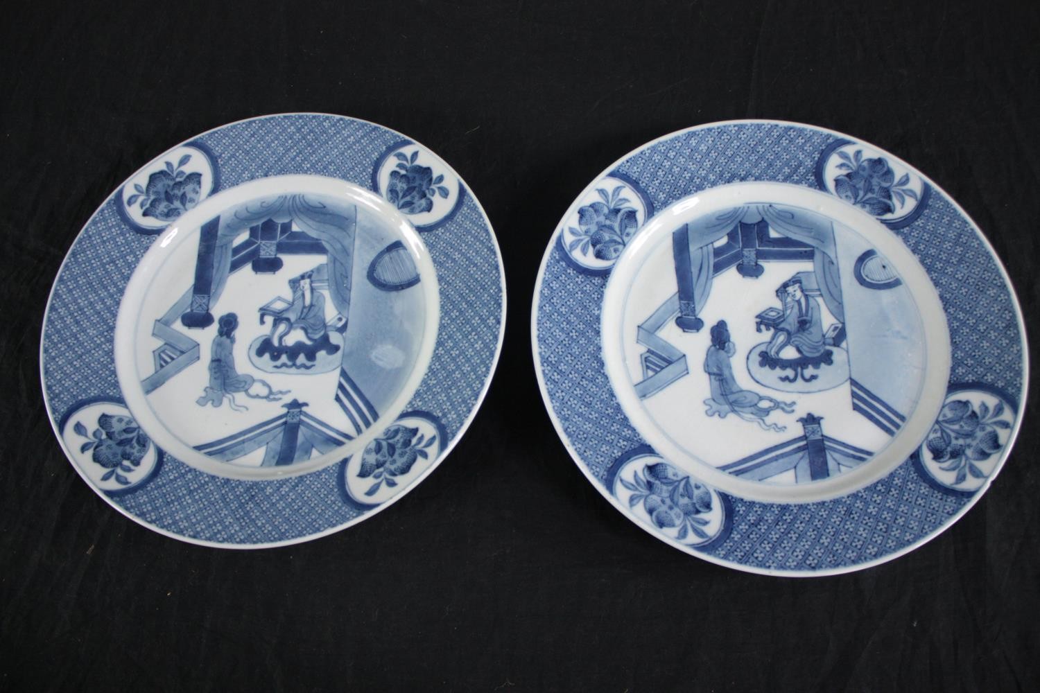 A pair of Qing dynasty Chinese blue and white china plates. Featuring a court scene withing a