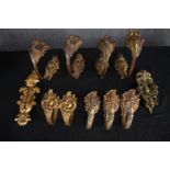 A collection of nine baroque style brass curtain (set of four, a pair and three) tie backs, a door