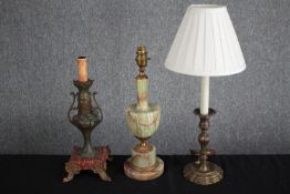 A collection of three table lamps. A mix of styles including two brass lamps and a classical style
