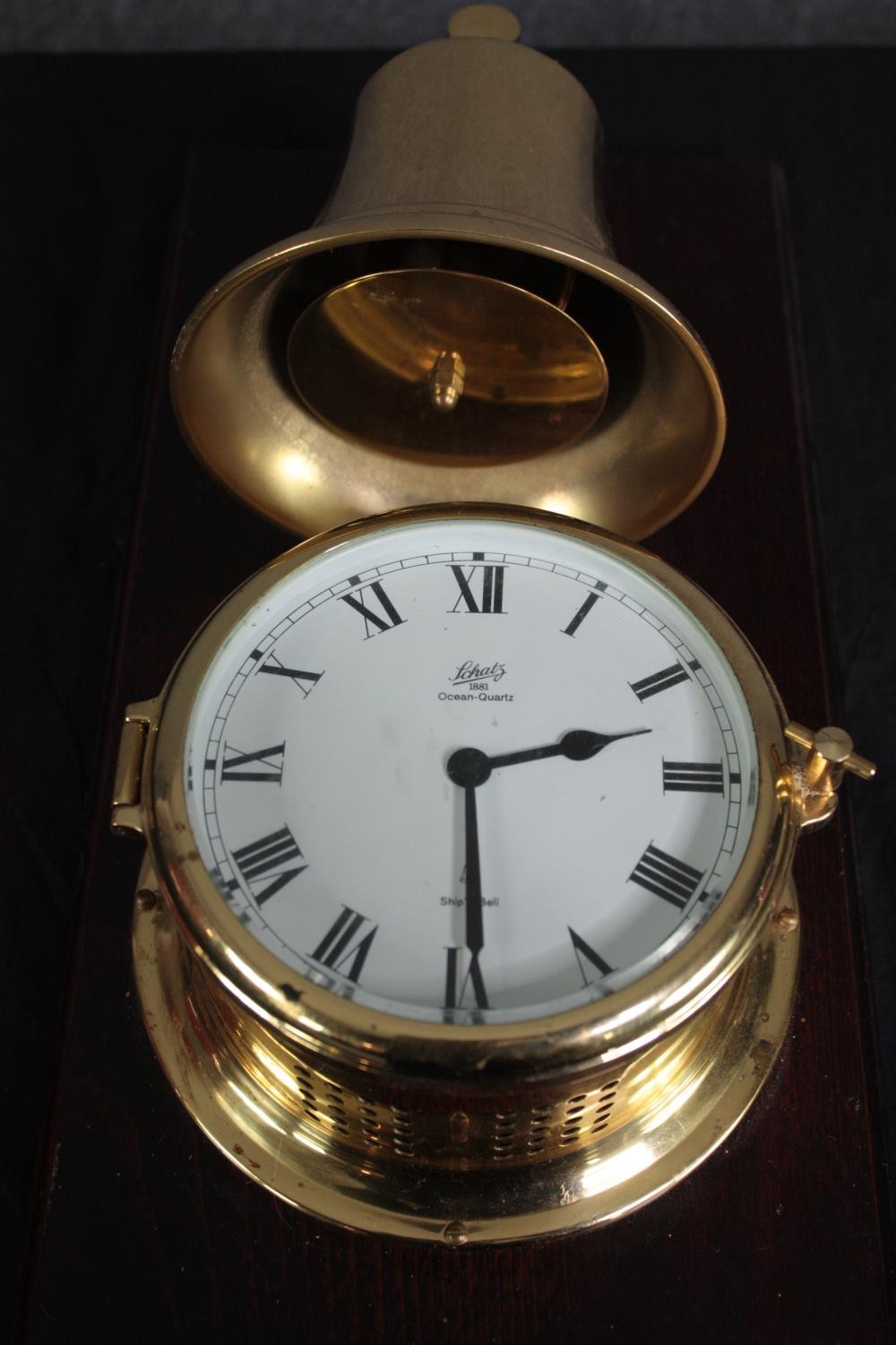 A brass cased Schatz clock with a bell mounted above. Ocean Quartz. H.42 W.22cm. - Image 2 of 5