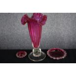 A Victorian decorative Cranberry glass trumpet vase with with ruffled edge and two small Cranberry