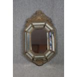 Wall mirror, C.1900 Dutch style in repousse metal cushion frame. H.109 W.62cm.