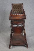 An early 20th century oak metamorphic high chair. H.97 W.47 D.56cm.