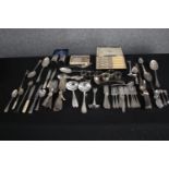 A mixed collection of silver plated cutlery and flatware including napkin rings and ladles. L.
