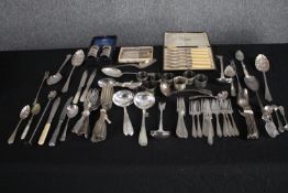 A mixed collection of silver plated cutlery and flatware including napkin rings and ladles. L.