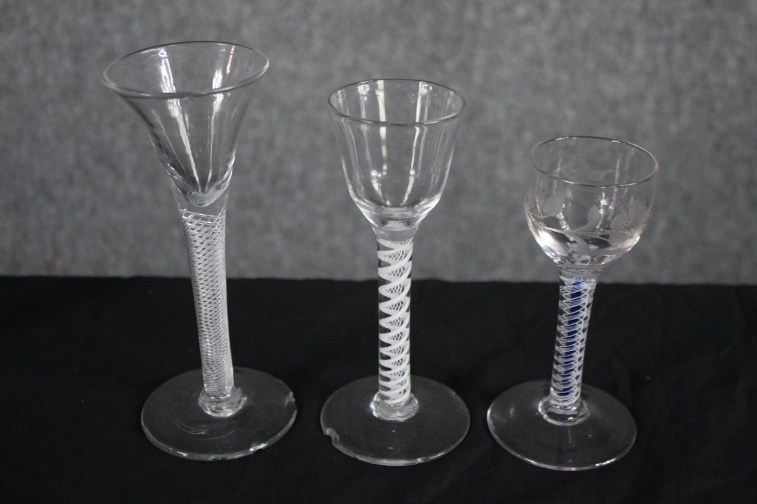 A mixed collection of six 18th and 19th century air twist stem wine glasses. One with a royal blue - Image 3 of 3