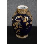 Royal Worcester. A china vase with a deep blue glaze and ribbon and floral decoration. Early to