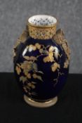 Royal Worcester. A china vase with a deep blue glaze and ribbon and floral decoration. Early to