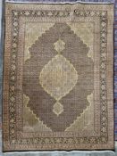 A Persian style carpet with central lozenge medallion on a midnight ground within naturalistic