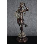 A spelter figure of a flower girl in flowing dress mounted on a turned base. H.43cm.