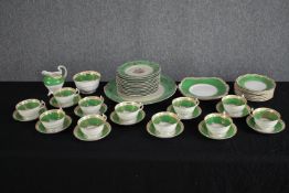 A German porcelain tea set for eleven people. 1930s Konig teacup & saucer, plates and creamer. In