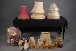 A large assortment of lamp shades, some silk with tassel edging. Dia.59cm. (largest)