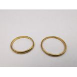 Two 22 carat yellow gold D-shape wedding bands. Hallmarked:London, 1960 and 1927. Ring size Q and M.