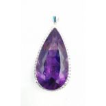 A contemporary 18ct white gold amethyst and diamond statement drop pendant. The pendant set with a