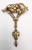 A 19th century yellow metal (tests as higher than 9ct) articulated brooch set with natural seed