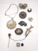 A collection of early 20th century silver brooches and silver jewellery, including a silver repousse