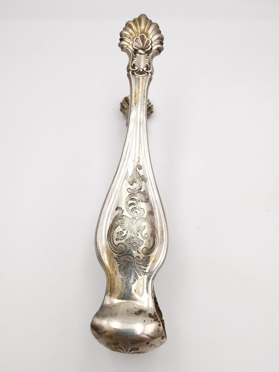 A collection of silver and white metal items, including a pair of sugar tongs with engraved - Image 8 of 16