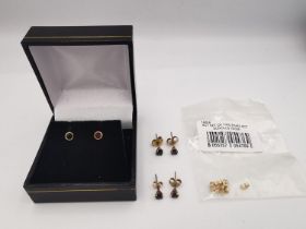 A collection of yellow metal gem set stud earrings and a bag containing three pairs of 9ct yellow