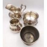 A matching German silver milk jug and sugar bowl, along with a small German silver vase and an