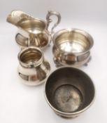 A matching German silver milk jug and sugar bowl, along with a small German silver vase and an