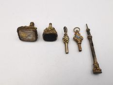A collection of early 20th century rolled gold fobs, pocket watch keys and a miniature sliding