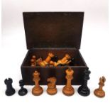 A 19th century weighted boxwood and ebony Staunton chess set in an oak 19th century box with