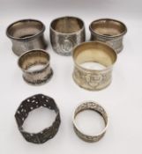 A collection of seven silver napkin rings, including an etched silver napkin ring by Gunther Theodor