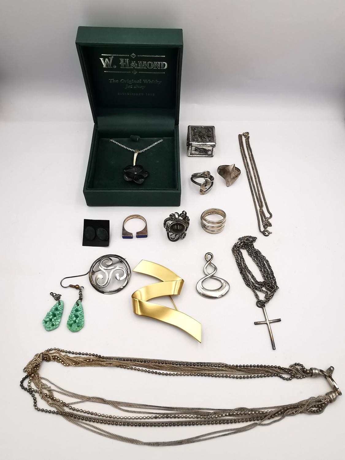 A collection of jewellery, including a Whitby carved jet and silver flower necklace, a silver and