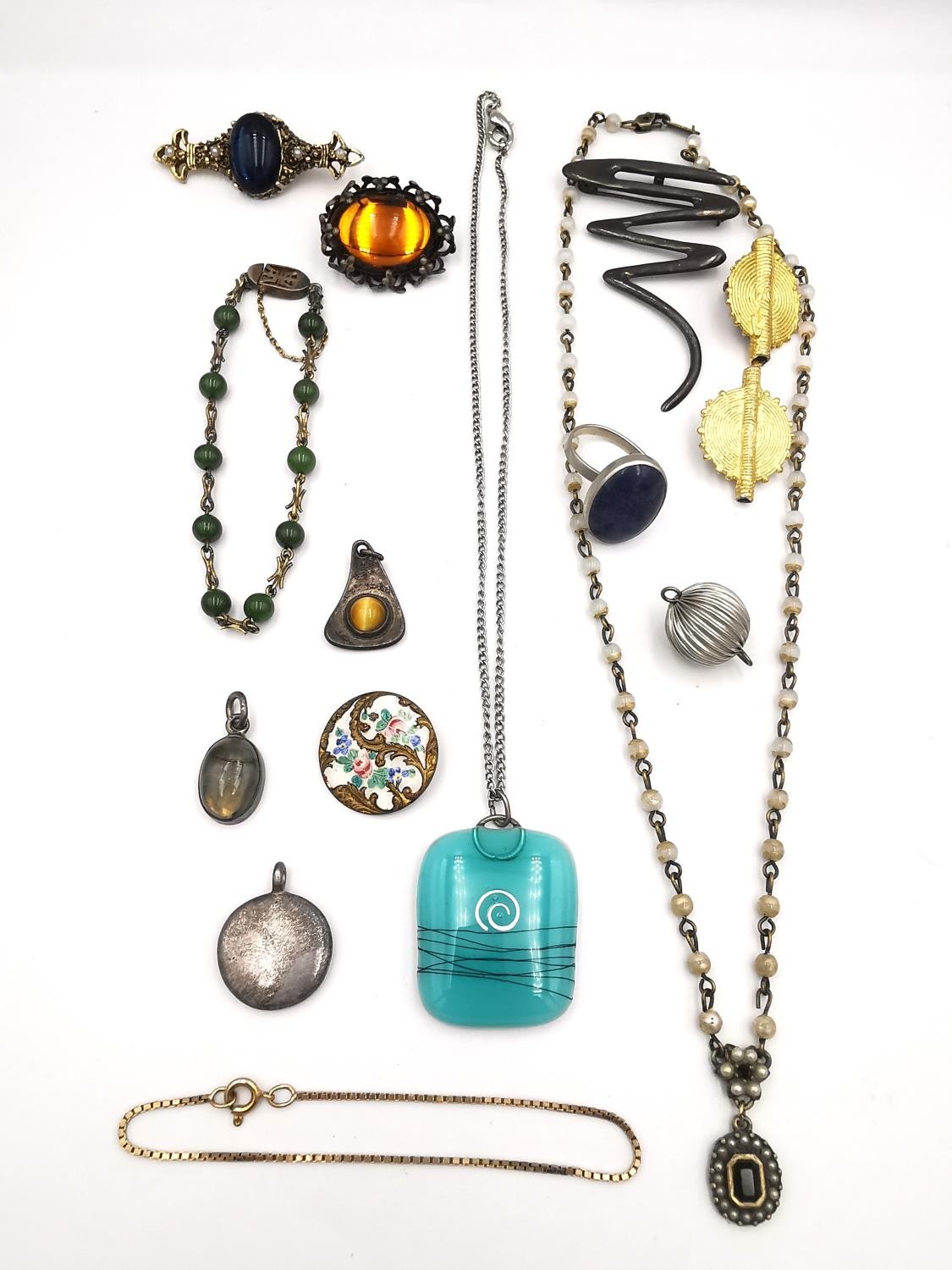 A collection of jewellery, including a Chinese silver gilt jade bead bracelet, a silver squiggle