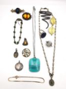 A collection of jewellery, including a Chinese silver gilt jade bead bracelet, a silver squiggle