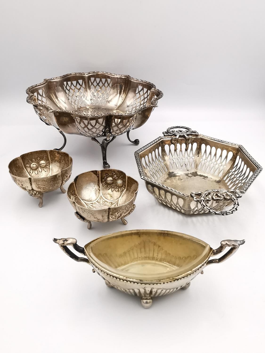 A collection of silver salts and bon bon dishes, including a pair of repousse rose design salts by