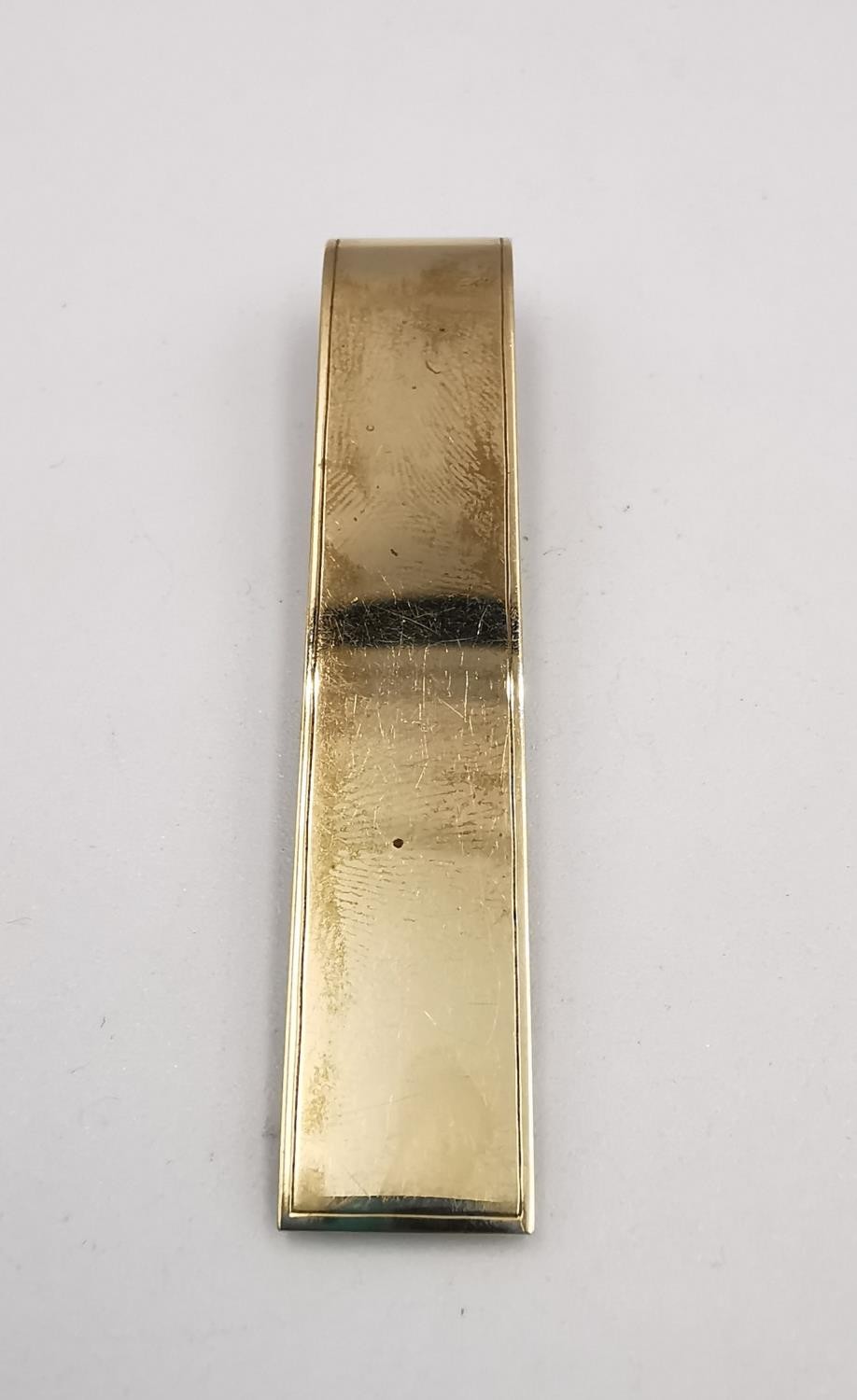 A yellow metal (tests as 9ct) yellow gold and diamond money clip. The clip adorned with the letter Y - Image 4 of 4