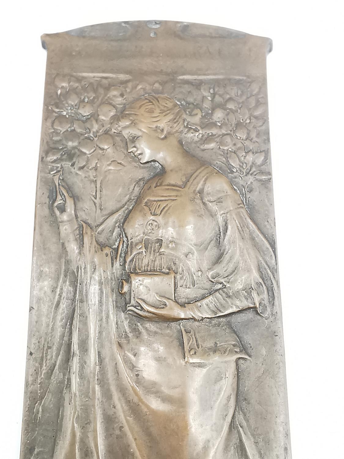 An Art Nouveau bronze relief plaque of a lady in flowing dress holding a magic lantern among blossom - Image 4 of 5