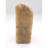 A 19th century carved Chinese soapstone seal with relief lotus leaf, pod and bird decoration. The