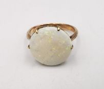 An early 20th century pink metal (tests as 9ct) white opal dress ring, set with a round white opal
