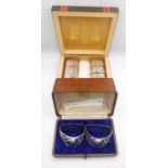 Two cases of silver napkin rings, a set of eight oval Indian silver napkin rings with relief