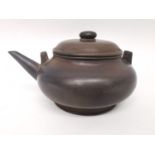 A Qing period Chinese polished Yixing clay teapot of squat rounded form. Impressed character mark to