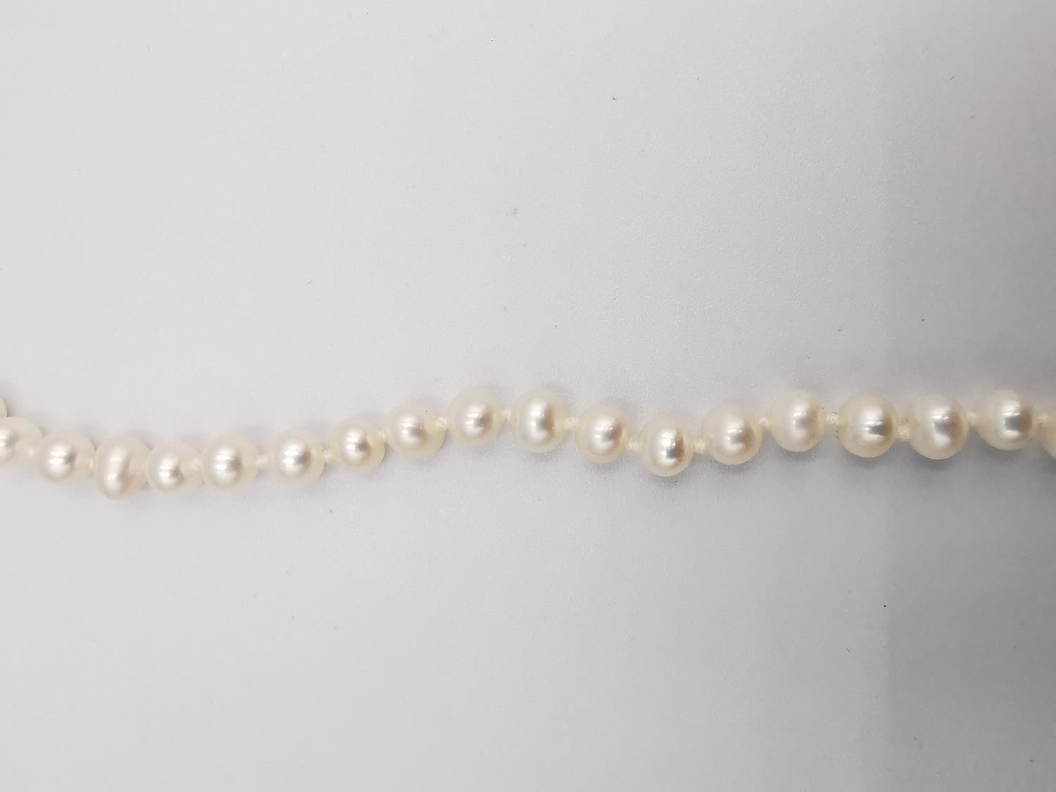 Two knotted white cultured pearl necklaces. One necklace with a 9ct bow shaped hook and push - Image 9 of 10