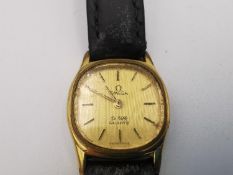 A ladies gold plated Omega de Ville quartz watch with black leather strap and steel back. The dial