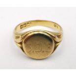 A Victorian 18ct yellow gold signet ring with circular cartouche engraved with a monogram, carved