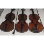 Three 19th and early 20th century violins, one with Antonius Stradivarius label in a mahogany case