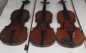 Three 19th and early 20th century violins, one with Antonius Stradivarius label in a mahogany case