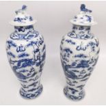 A pair of 19th century Chinese blue and white lidded dragon vases. Each vase decorated with four