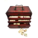 A 19th century rosewood cased bone and bamboo Mahjong set. (missing some tiles). The sliding door is